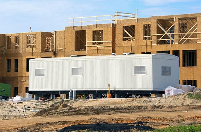 crane lifting modular building for construction office rentals in Compton